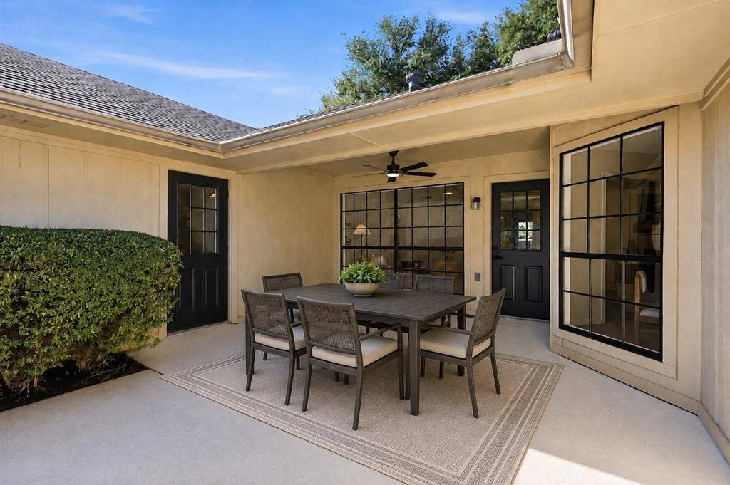 2411 Aspen Street, Richardson, TX 75082 Covered patio with concrete flooring, integrated ceiling fan, and multiple exterior doors with glass panels