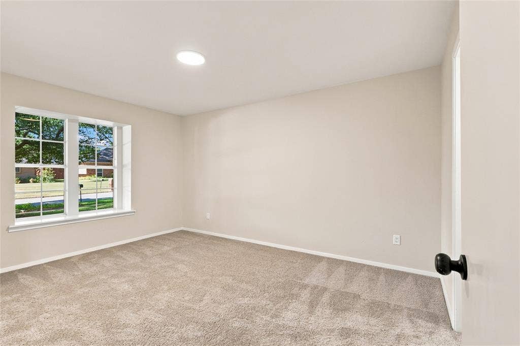 2411 Aspen Street, Richardson, TX 75082 Neutral-toned wall paint, recessed ceiling lighting, light-colored carpeting, white window trim, and a black doorknob