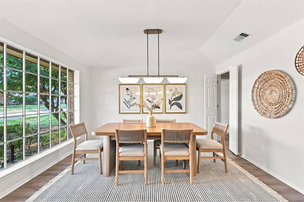 2411 Aspen Street, Richardson, TX 75082 Bright dining room anchored by a wood-finish table and chairs, illuminated by a linear pendant fixture