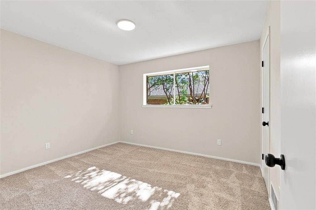 2411 Aspen Street, Richardson, TX 75082 Neutral-toned walls with plush carpeting