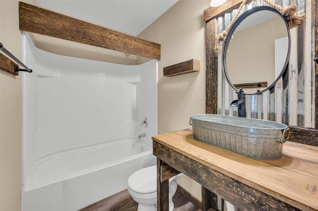 9017 Graywolf Ridge Trail, Fort Worth, TX 76244 Full bathroom featuring toilet, hardwood / wood-style flooring, shower combination, and large vanity