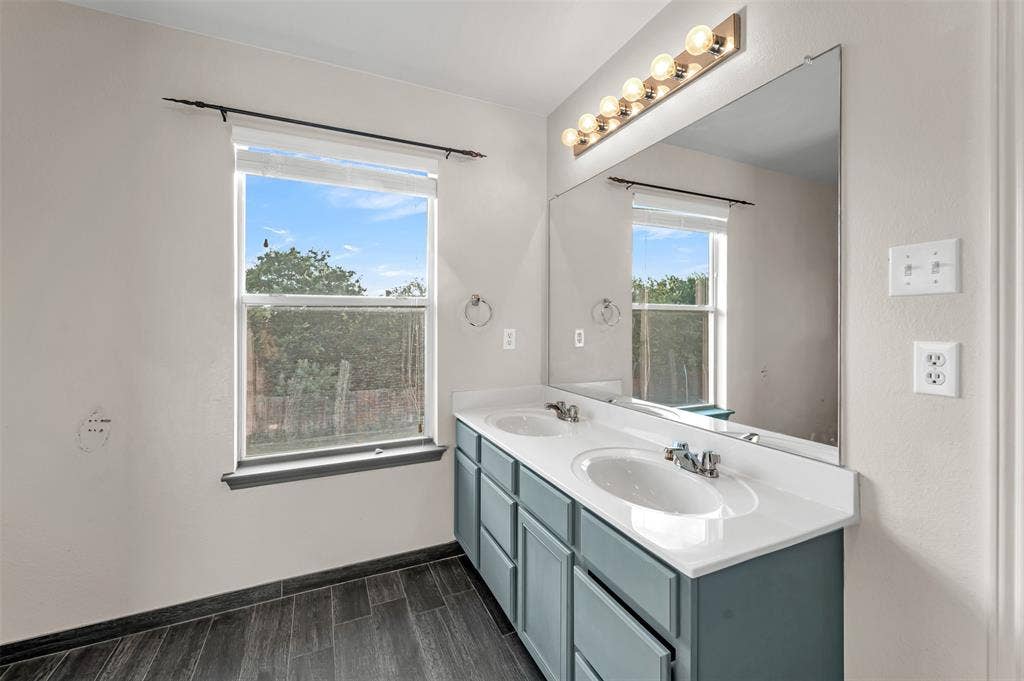 9017 Graywolf Ridge Trail, Fort Worth, TX 76244 Bathroom with double sink vanity and hardwood / wood-style floors