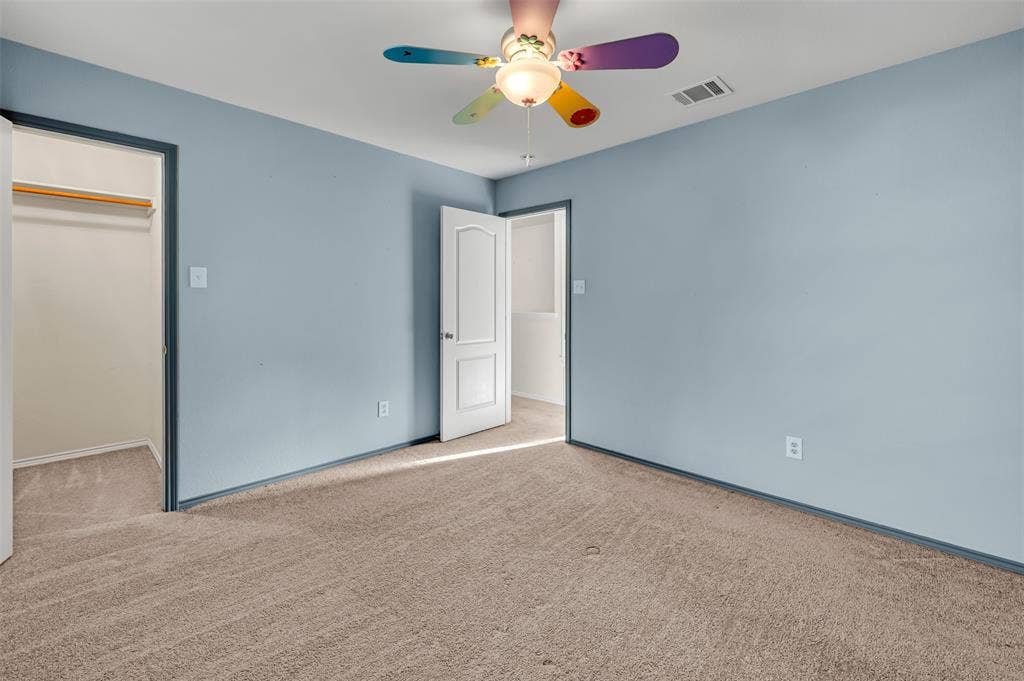 9017 Graywolf Ridge Trail, Fort Worth, TX 76244 Unfurnished bedroom featuring light carpet, a closet, and ceiling fan