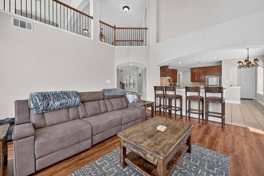 4612 Quiet Circle, Plano, TX 75024 Vaulted ceilings, wood-finish flooring, kitchen with built-in cabinetry, and a second-level open railing