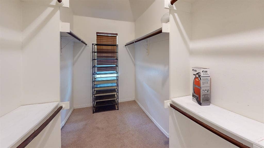 4651 Penelope Lane, Plano, TX 75024 Walk-in closet with carpeted flooring, built-in shelving, and hanging rods