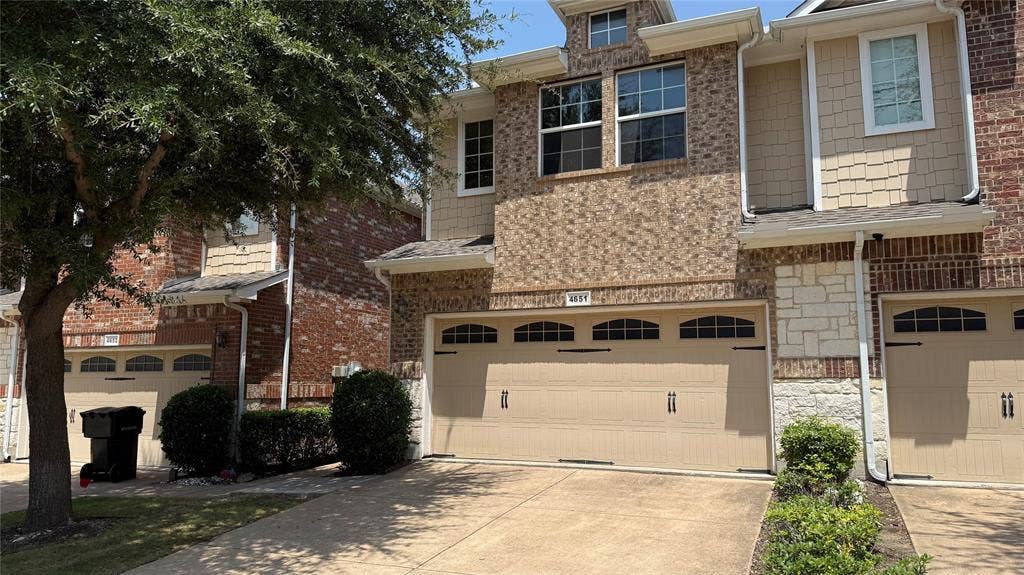 4651 Penelope Lane, Plano, TX 75024 Brick and stone facade with shake siding accents, two-car garage with arched window detailing, and mature landscaping
