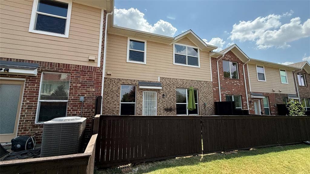4651 Penelope Lane, Plano, TX 75024 Multi-level residence featuring brick and siding exterior, multiple windows, and a private fenced yard space
