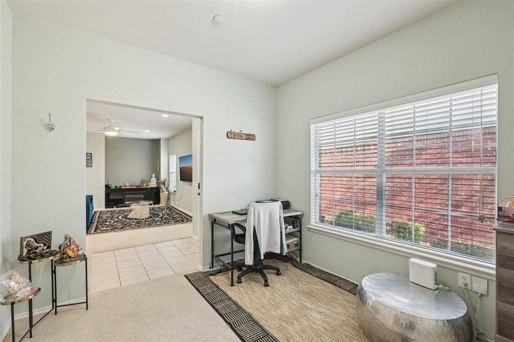 Recessed lighting, large window with blinds, carpeted flooring, and a wide entryway