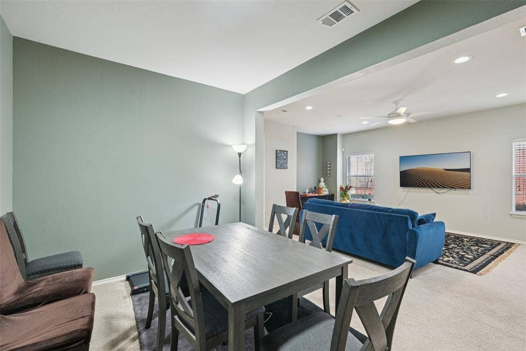 Open-concept living area with recessed lighting, ceiling fan, and carpeted flooring