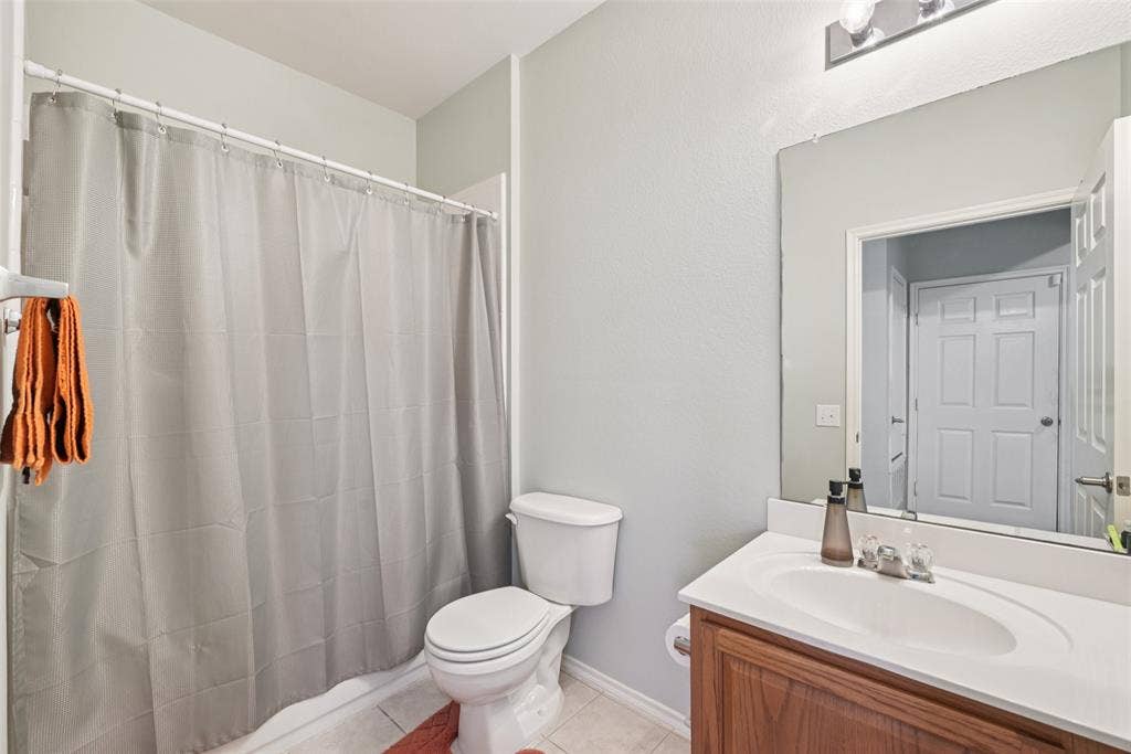 Bathroom with a spacious vanity, integrated sink, and wood-finish cabinetry