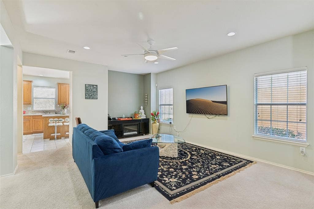 Recessed lighting, ceiling fan, and carpeted flooring in the living area