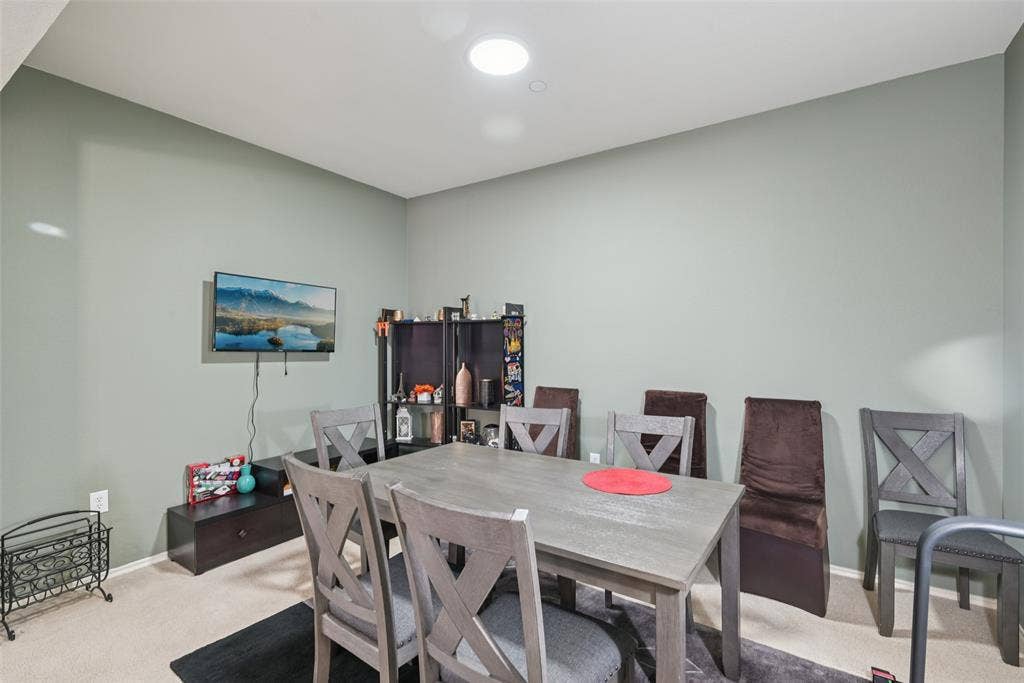 Recessed lighting, wall-mounted television, and neutral tone walls