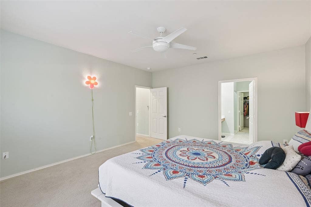 Wall-to-wall carpeting, white ceiling fan, and light-toned walls