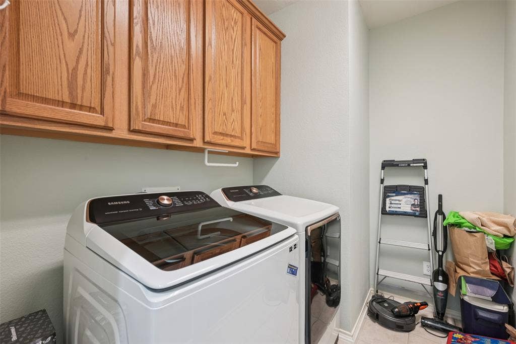 Laundry area with wood-finish upper cabinetry