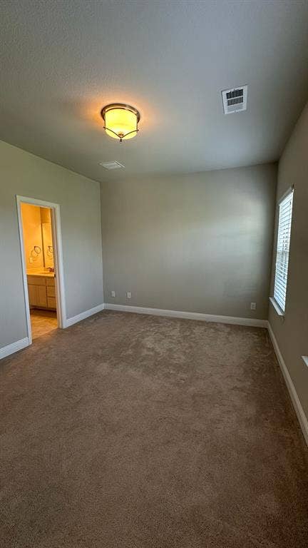 Expansive green lawn with a newly installed privacy fence, covered patio, and brick exterior