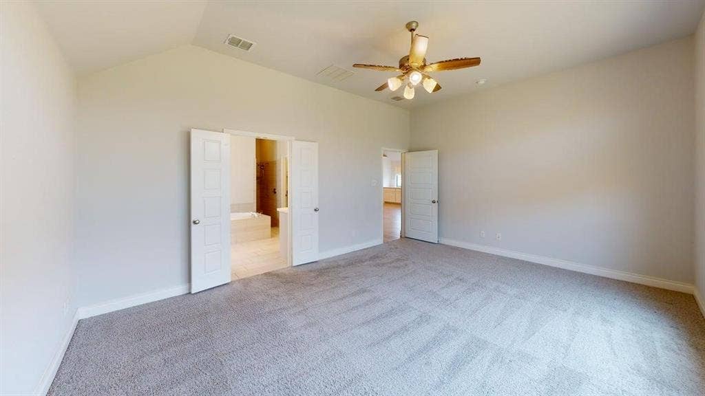 2401 Robin Way, Northlake, TX 76247 Vaulted ceiling with an attached ceiling fan, carpeted flooring, and double-panel doors