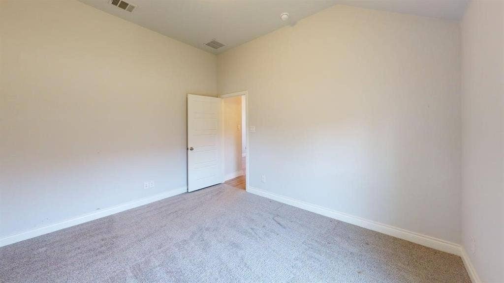 2401 Robin Way, Northlake, TX 76247 Neutral tone painted walls with a textured carpeted floor, white trim, and a contemporary panel interior door