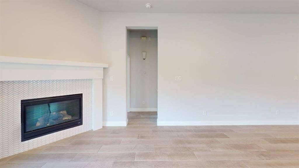 2401 Robin Way, Northlake, TX 76247 Contemporary fireplace with a herringbone tile surround and a substantial white mantel