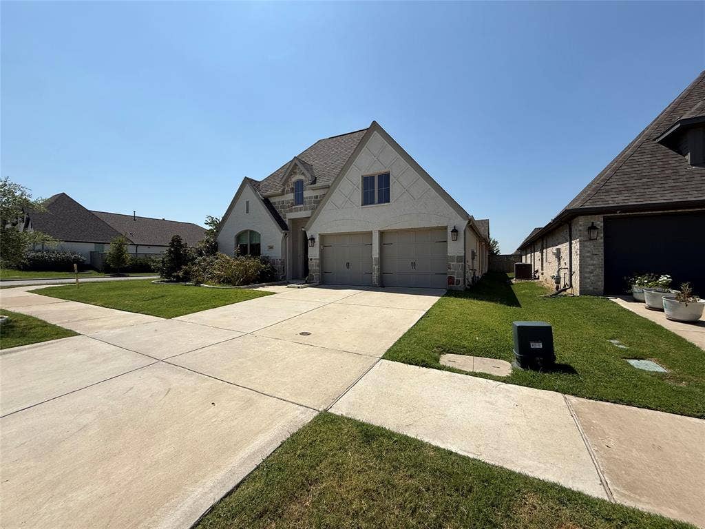 2401 Robin Way, Northlake, TX 76247 Exterior featuring a two-car garage, stone and stucco facade, and a concrete driveway