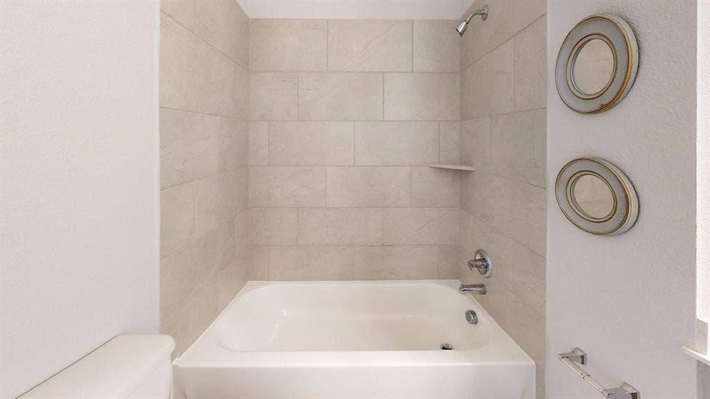 2401 Robin Way, Northlake, TX 76247 Bathtub with tile surround, built-in shelf, and chrome fixtures