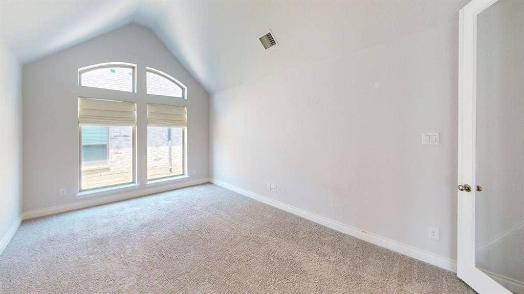 2401 Robin Way, Northlake, TX 76247 Vaulted ceiling with arched window accents, light-colored carpeting, and a white interior door