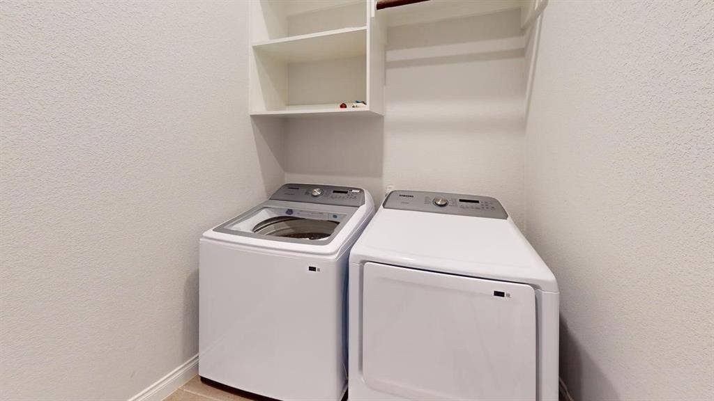 2401 Robin Way, Northlake, TX 76247 Laundry area with built-in shelving, a top-load washer, and a front-load dryer