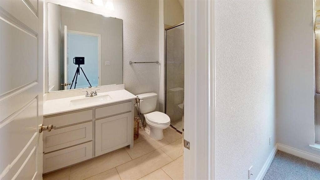 2401 Robin Way, Northlake, TX 76247 Vanity with a single sink, light-colored countertop, and framed mirror