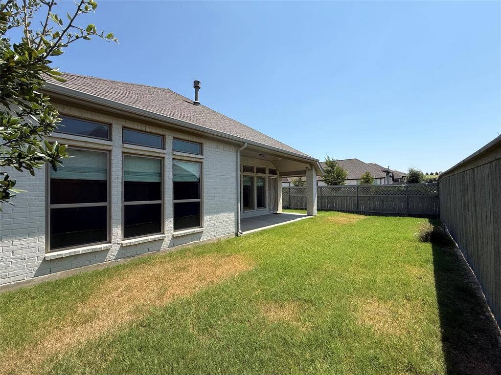 2401 Robin Way, Northlake, TX 76247 Spacious backyard featuring a covered patio, extensive lawn, and privacy fencing