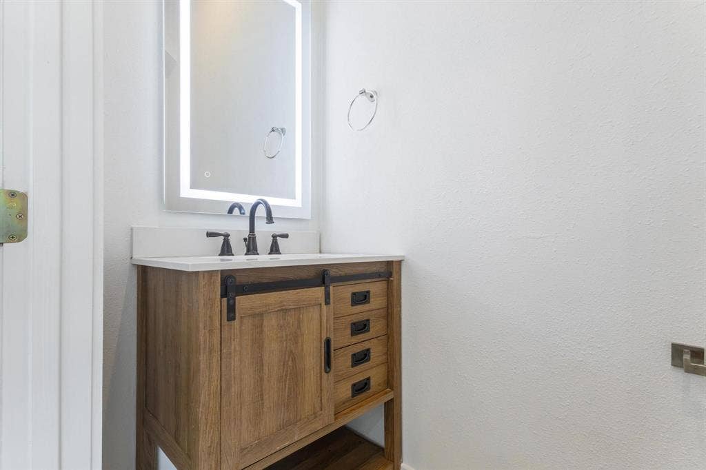2450 N Garrett Avenue, #14, Dallas, TX 75206 Wood-finish vanity with a white countertop and undermount sink