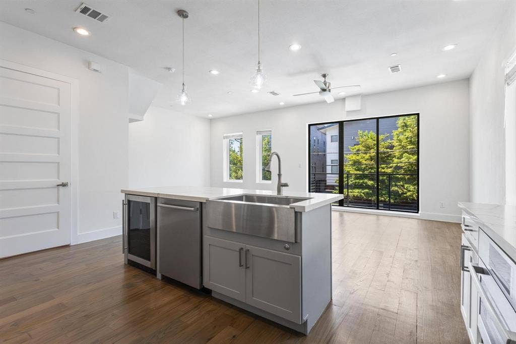 2450 N Garrett Avenue, #14, Dallas, TX 75206 Kitchen island with a stainless steel farmhouse sink and integrated dishwasher