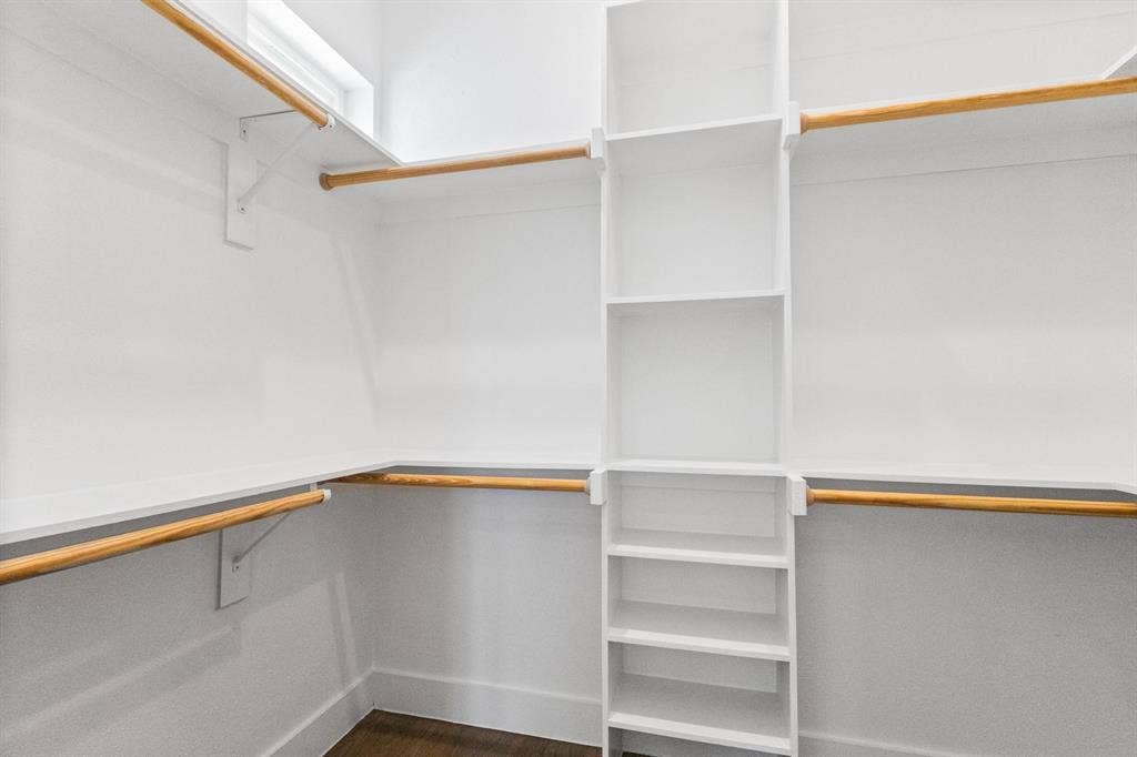 2450 N Garrett Avenue, #14, Dallas, TX 75206 Built-in closet system with shelving, hanging rods, and wood-finish flooring