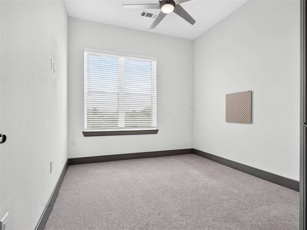 2700 Old Denton Road, #2212, Carrollton, TX 75007 Carpeted room with a ceiling fan, window with blinds, and dark-toned trim