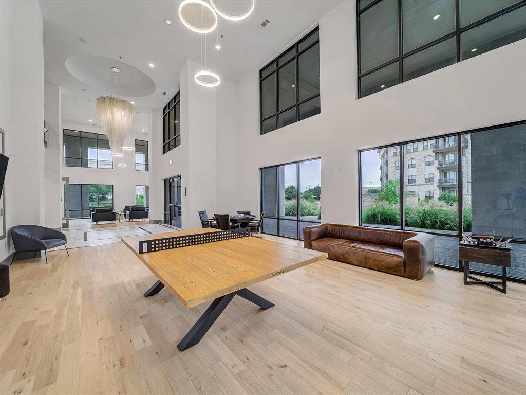 2700 Old Denton Road, #2212, Carrollton, TX 75007 Soaring ceilings with extensive window detailing and light wood-finish flooring