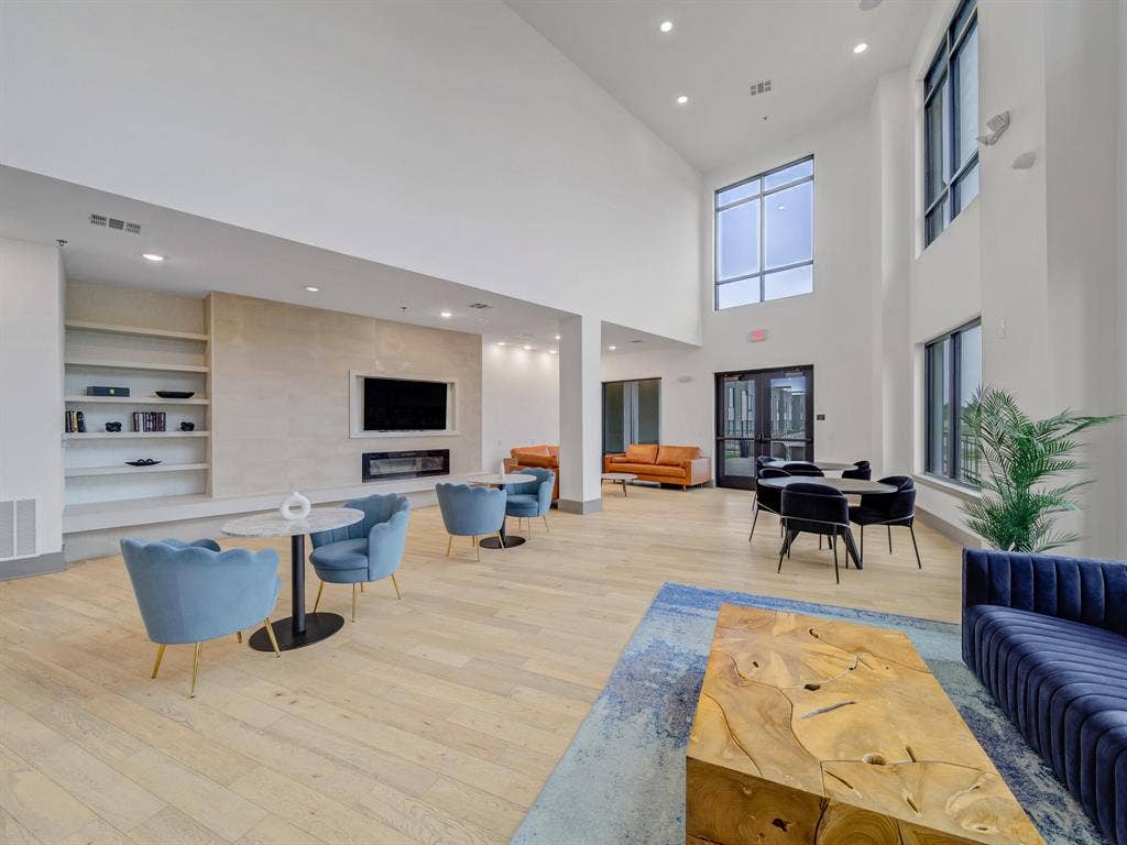 2700 Old Denton Road, #2212, Carrollton, TX 75007 High ceilings, wood-finish flooring, built-in shelving, fireplace, and large windows