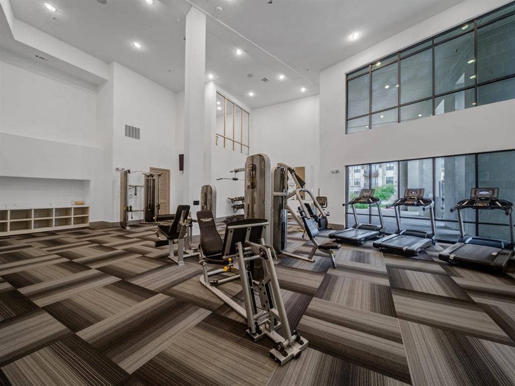 2700 Old Denton Road, #2212, Carrollton, TX 75007 Fitness center featuring high ceilings, recessed lighting, expansive windows, modular carpet flooring, and integrated shelving