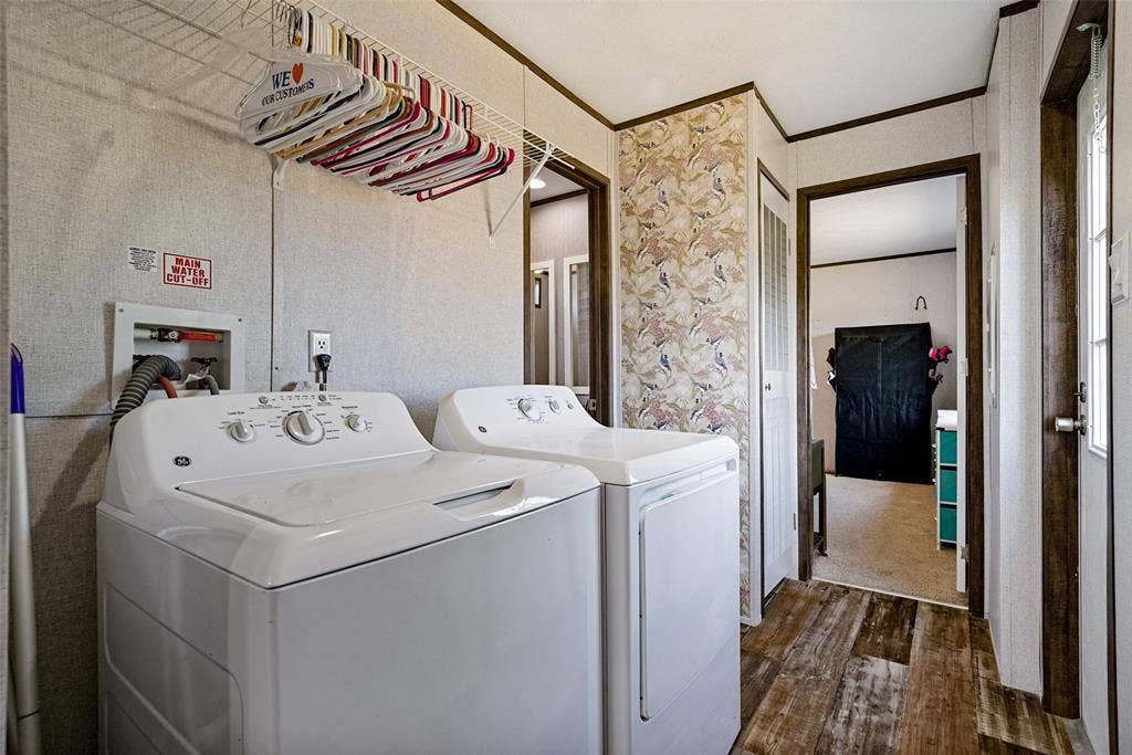 4415 Woodland Drive, Granbury, TX 76048 Dedicated laundry area featuring wood-finish flooring, included appliances, and a wire rack storage solution