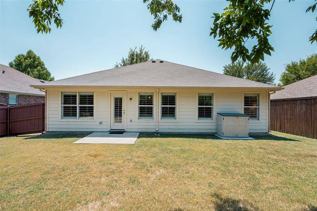 3707 Redwood Circle, Melissa, TX 75454 Expansive rear yard featuring a concrete patio, exterior siding, multiple windows with shutters, and a storage shed