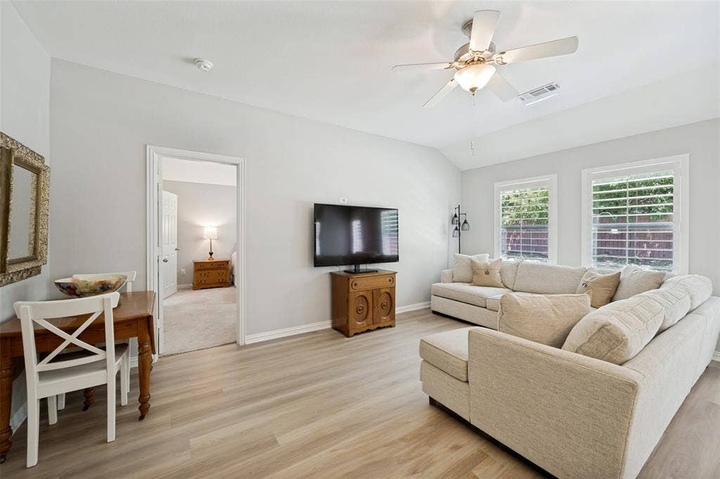 3707 Redwood Circle, Melissa, TX 75454 Vaulted ceilings, wood-finish flooring, ceiling fan, and two windows with plantation shutters
