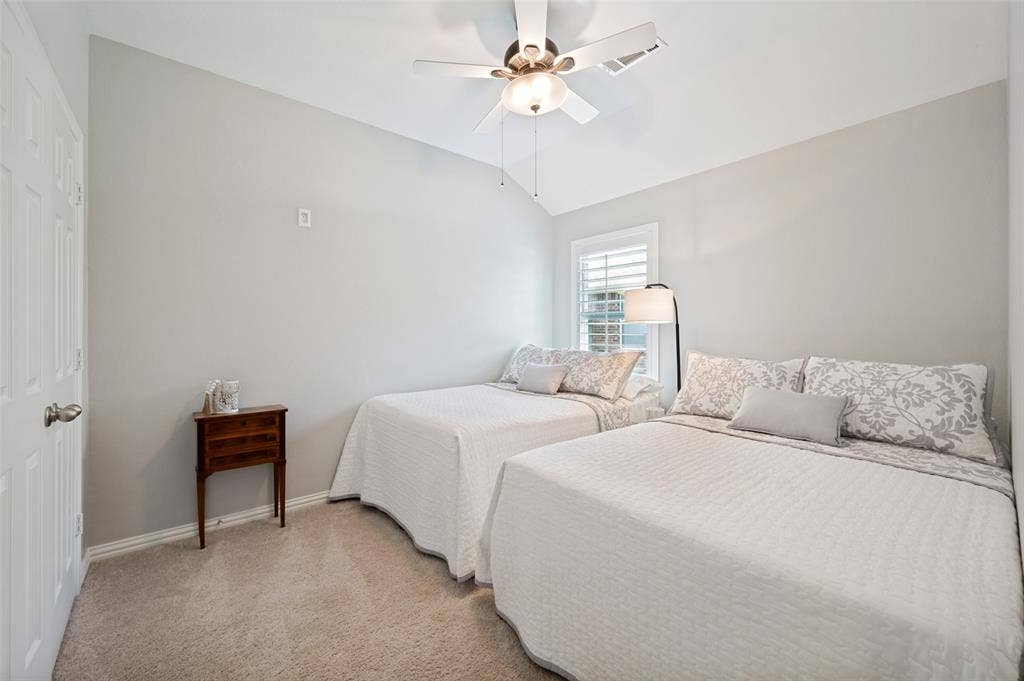 3707 Redwood Circle, Melissa, TX 75454 Raised ceiling with a ceiling fan, window with white plantation shutters, and light-colored wall-to-wall carpeting