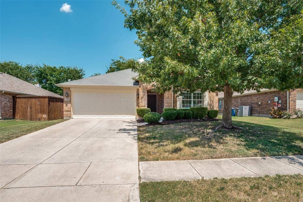 3707 Redwood Circle, Melissa, TX 75454 Concrete driveway and brick exterior with a two-car garage