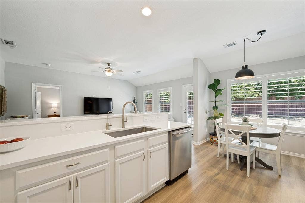 3707 Redwood Circle, Melissa, TX 75454 Kitchen featuring white cabinetry, light-toned countertops, a stainless steel sink, and wood-finish flooring
