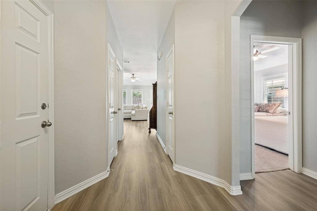 3707 Redwood Circle, Melissa, TX 75454 Hallway featuring wood-finish flooring, light-toned walls, and white trim