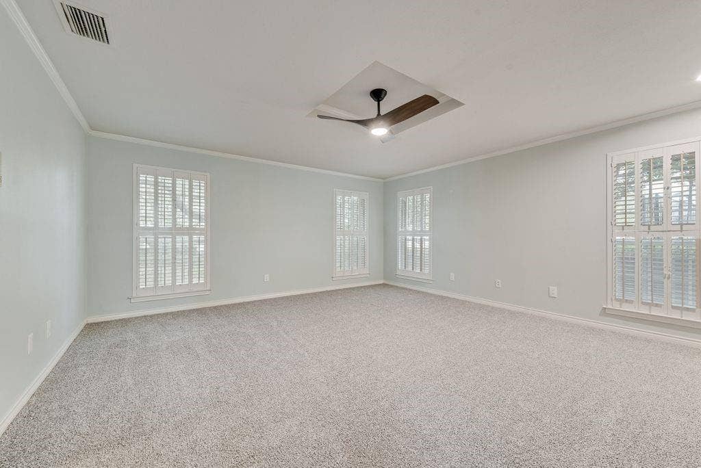 2 Eastshore Road, Heath, TX 75032 Spacious room featuring light-colored walls, crown molding, and plush carpeting