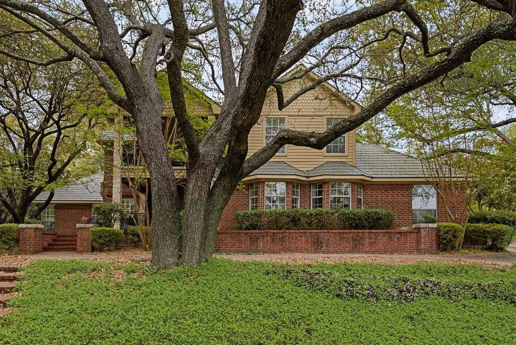 2 Eastshore Road, Heath, TX 75032 Brick exterior with bay windows and a shingle roof