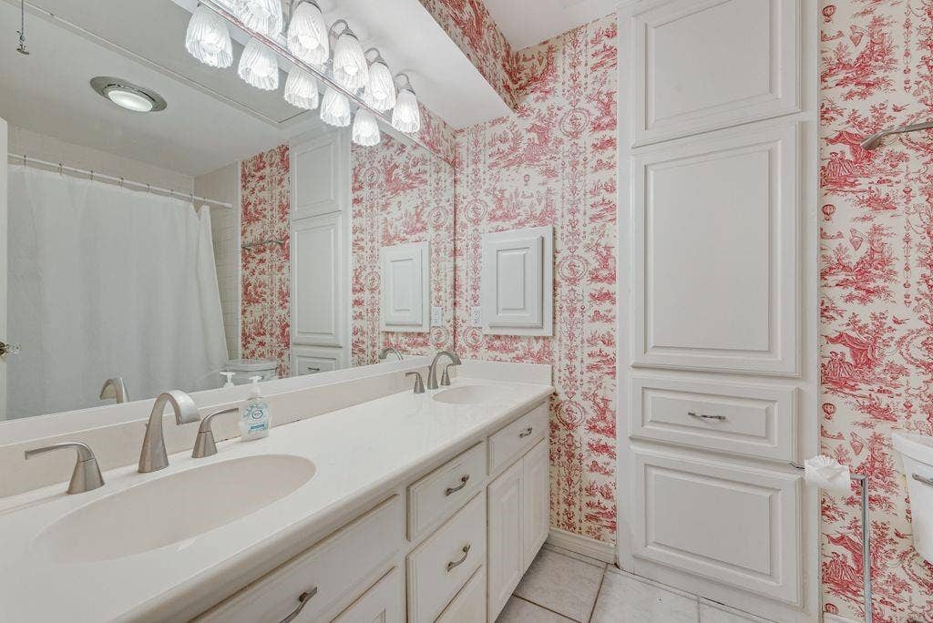 2 Eastshore Road, Heath, TX 75032 Dual vanity with integrated sinks, brushed nickel fixtures, and a multi-bulb lighting fixture