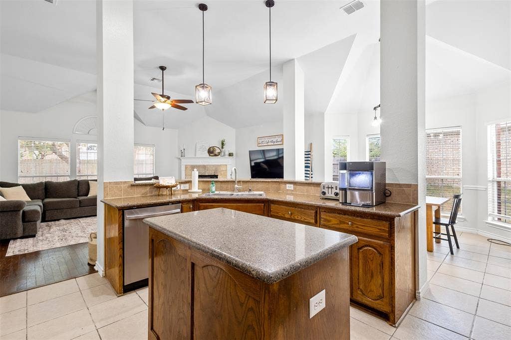 5413 Compassion Drive, Midlothian, TX 76065 Kitchen featuring wood cabinetry, light countertops, and a stainless steel dishwasher