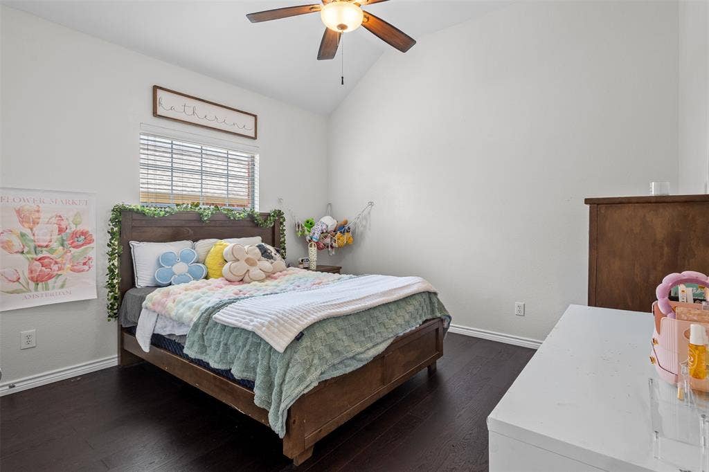 5413 Compassion Drive, Midlothian, TX 76065 Vaulted ceiling with a ceiling fan, window with blinds, and dark wood-finish flooring