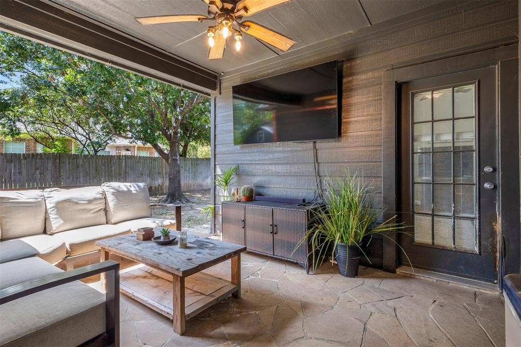 5413 Compassion Drive, Midlothian, TX 76065 Covered patio featuring flagstone flooring, wood-paneled walls, and a ceiling fan