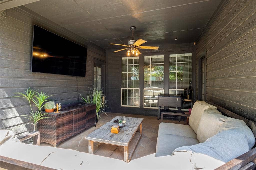 5413 Compassion Drive, Midlothian, TX 76065 Covered patio featuring flagstone flooring, wood-paneled walls, and a ceiling fan