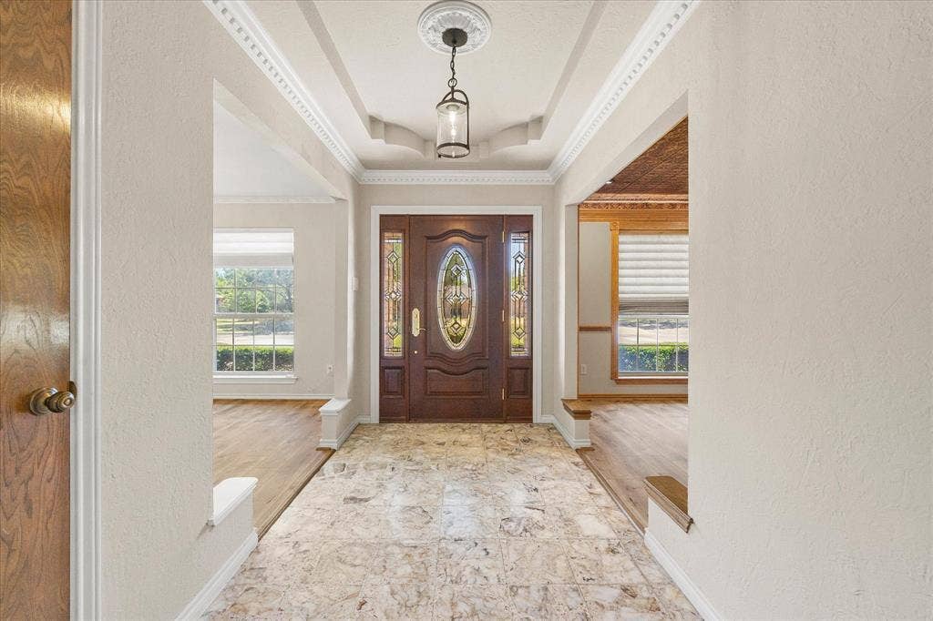 4001 Keele Drive, Garland, TX 75041 A welcoming entry featuring a beautiful front door, detailed ceiling, and marble tile flooring.